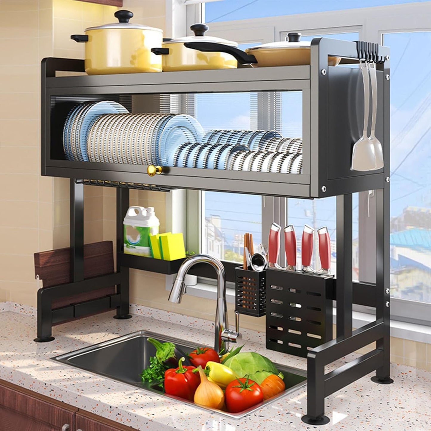 Kitchen dish rack with dishes and utensils next to a sink with vegetables.